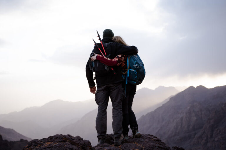 Mountaineer silhouetted against sunrise on High Atlas mountain ridge Morocco