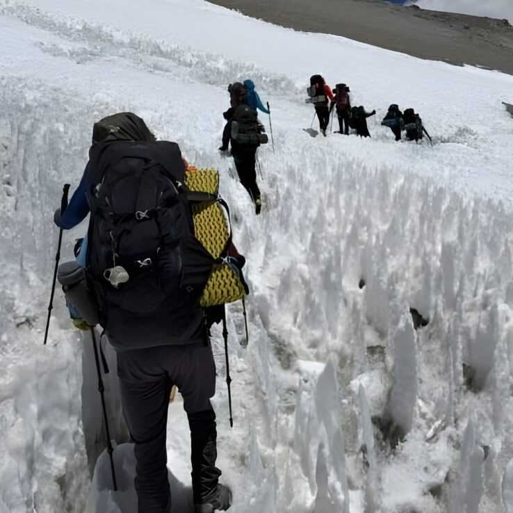 Athletes performing hill repeat training for high altitude mountaineering preparation in Aconcagua