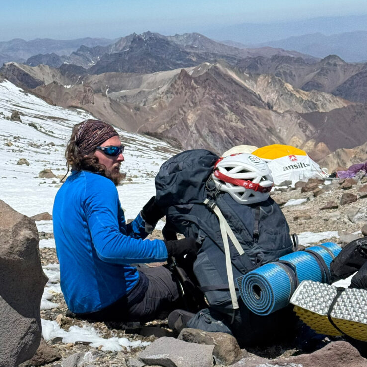 Exhausted climber showing effects of extreme altitude on Aconcagua